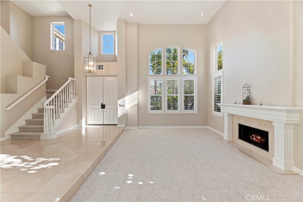 8 Nidden Irvine, CA 92603 - Photo 10 of 77 a view of an empty room with a fireplace and a window