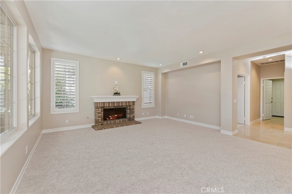 8 Nidden Irvine, CA 92603 - Photo 20 of 77 a view of a livingroom with a fireplace and window