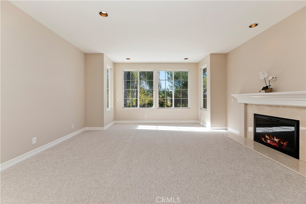 8 Nidden Irvine, CA 92603 - Photo 32 of 77 a view of an empty room with a window and fireplace