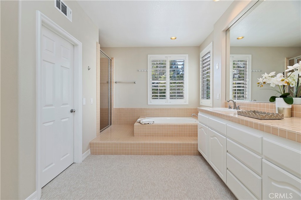 8 Nidden Irvine, CA 92603 - Photo 35 of 77 a spacious en suite bathroom with a granite countertop tub and a sink