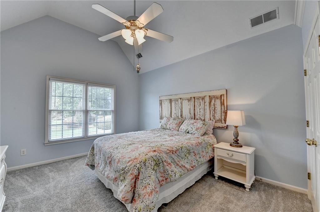 964 Fairview Club Circle Dacula, GA 30019 - Photo 23 of 47 a bedroom with a bed chandelier and a window