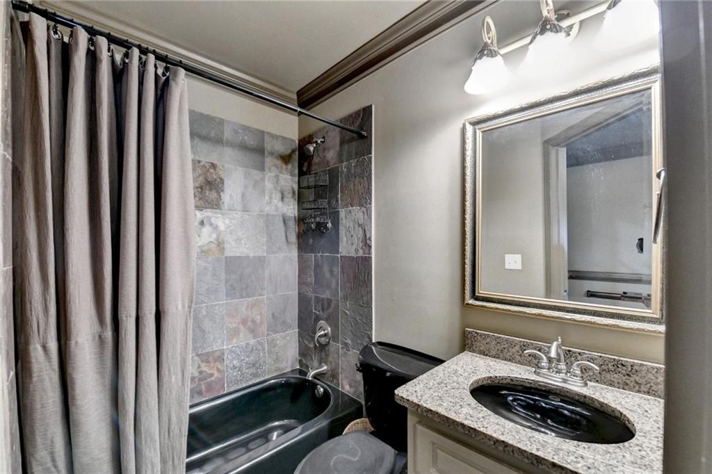 964 Fairview Club Circle Dacula, GA 30019 - Photo 34 of 47 a bathroom with a sink a mirror and a shower