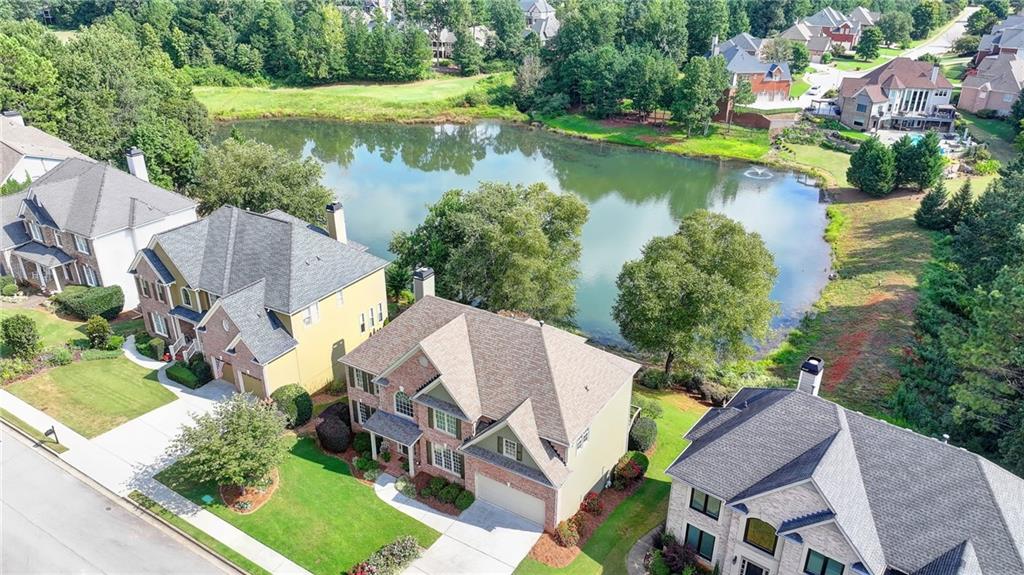 964 Fairview Club Circle Dacula, GA 30019 - Photo 41 of 47 an aerial view of a house with a garden and lake view