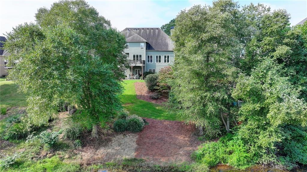 964 Fairview Club Circle Dacula, GA 30019 - Photo 43 of 47 an aerial view of a house with a yard and large trees