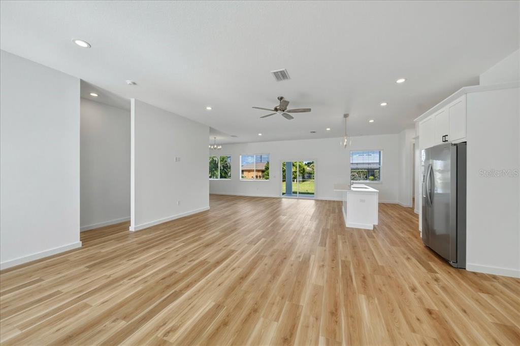 1215 Rio De Janeiro Avenue Punta Gorda, FL 33983 - Photo 26 of 65 a view of a kitchen with a fridge and wooden floor