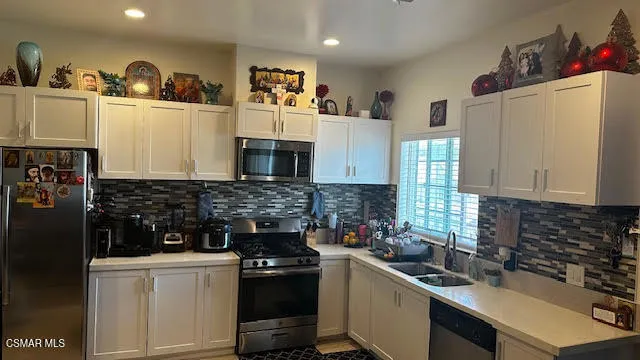 a kitchen with a sink stove and refrigerator