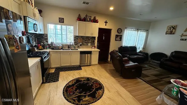 a kitchen with a refrigerator and a stove