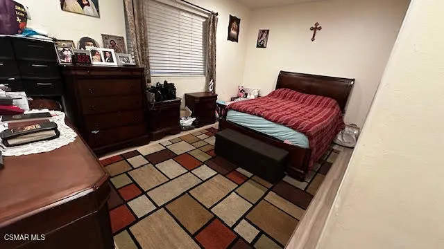 a bedroom with a bed and a dresser