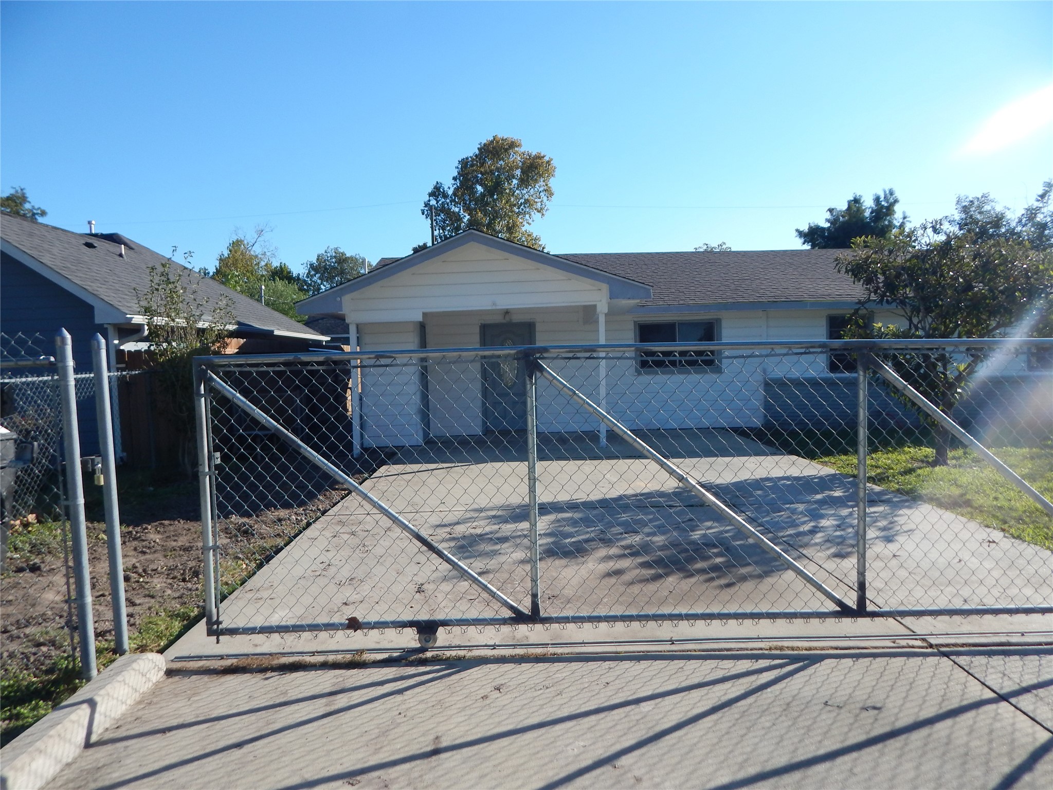 206 Arnett Lane Houston, TX 77037 - Photo 22 of 28 a view of a house with a small yard and large trees