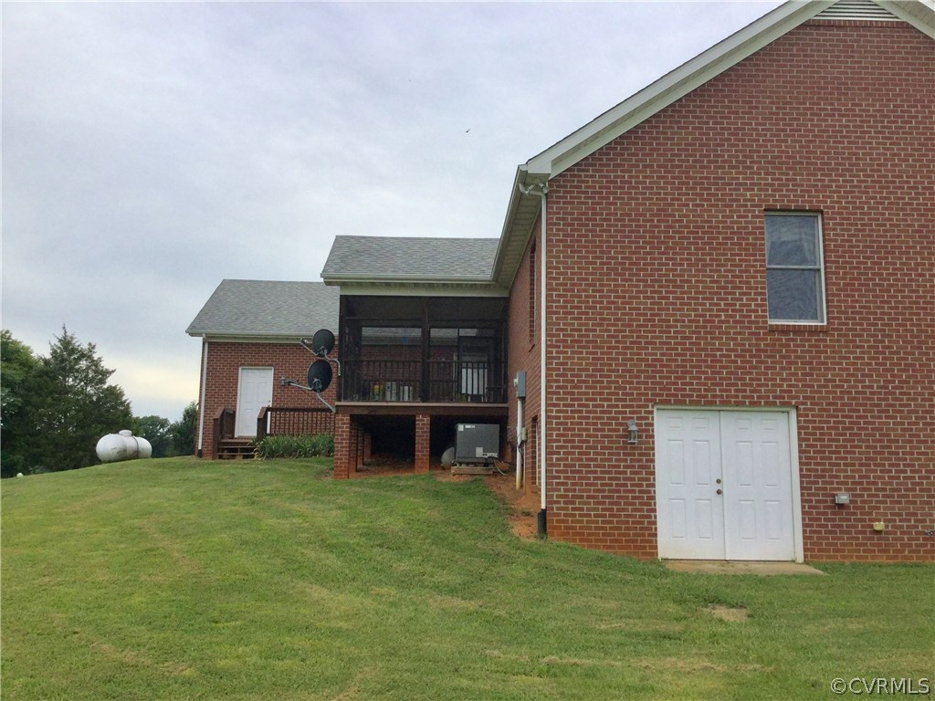 4361 Three Chopt Road Gum Spring, VA 23065 - Photo 7 of 49 a front view of a house with a yard and garage