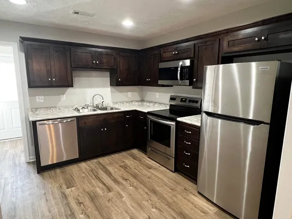 a kitchen with stainless steel appliances a refrigerator and a sink