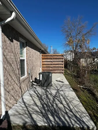 a view of house with backyard and sitting area