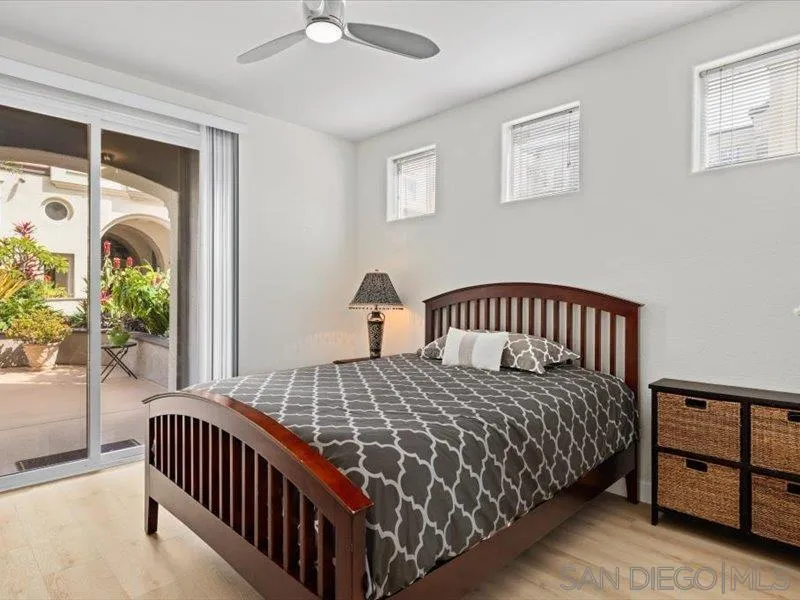 9237 Regents Road, Unit K101 La Jolla, CA 92037 - Photo 11 of 29 a bedroom with a bed and a window