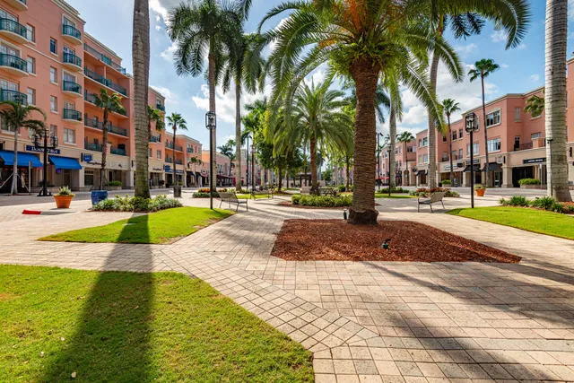 a view of a swimming pool with a lawn chair and palm trees