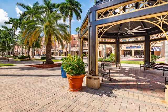 a view of a brick house with potted plants