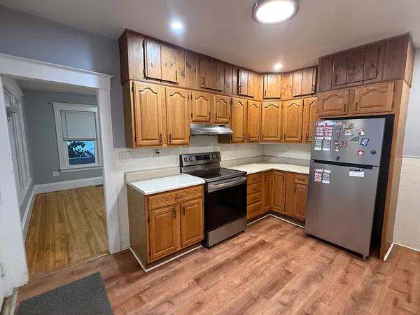a kitchen with stainless steel appliances granite countertop a refrigerator and a stove
