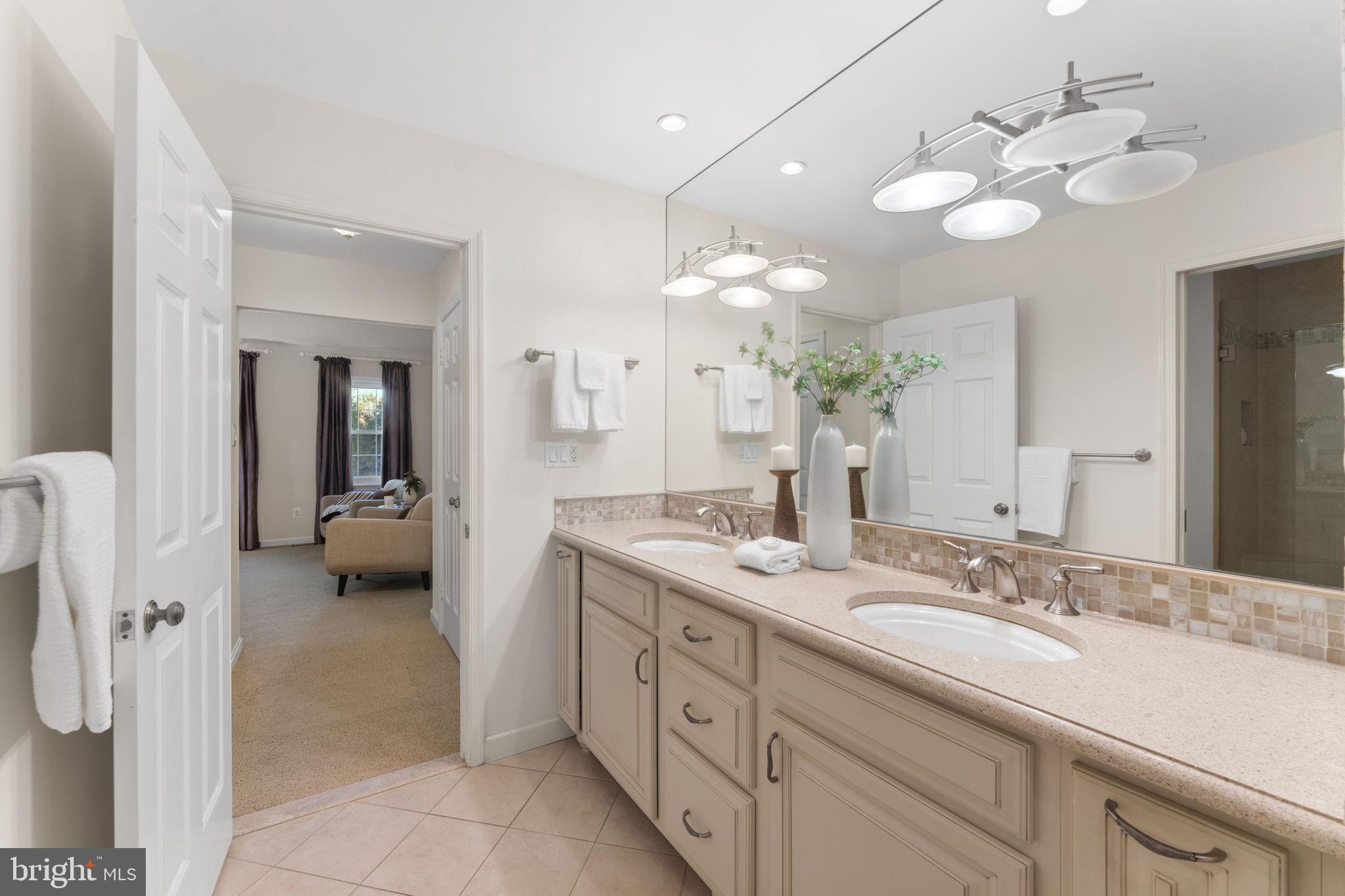 6619 Madison McLean Drive McLean, VA 22101 - Photo 23 of 54 a spacious en suite bathroom with a double vanity sink and a mirror