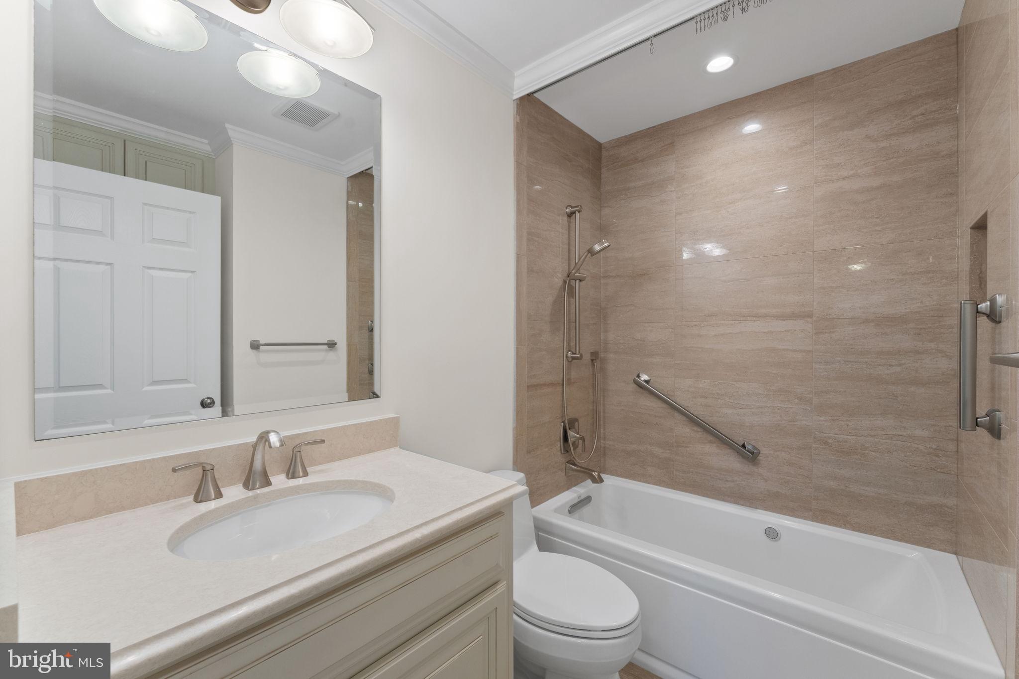 6619 Madison McLean Drive McLean, VA 22101 - Photo 29 of 54 a bathroom with a granite countertop sink a toilet and bathtub