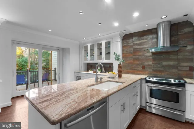 a kitchen with a refrigerator and a stove top oven