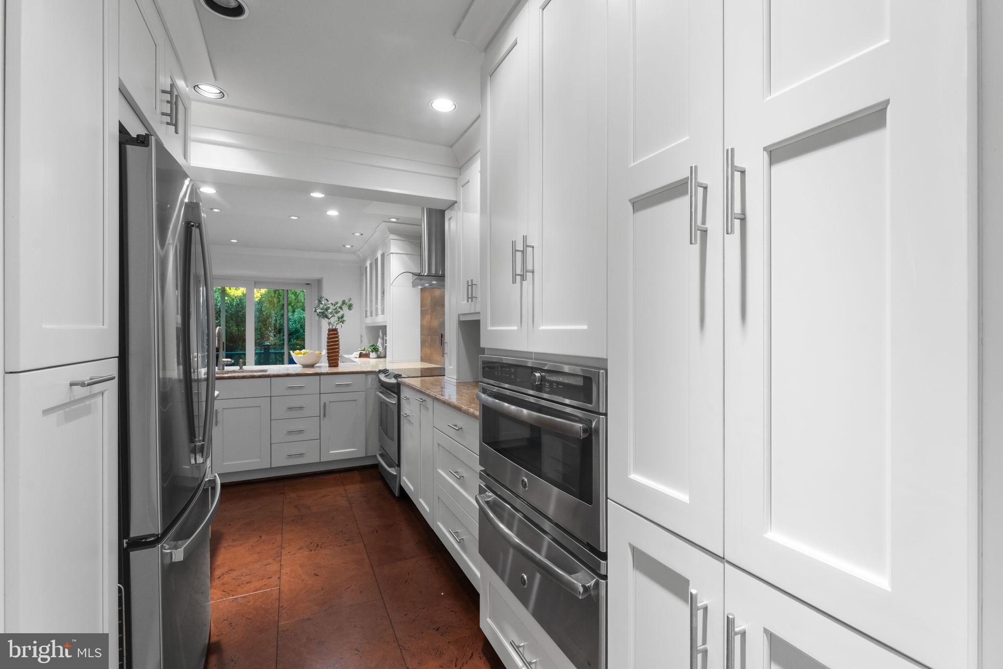 6619 Madison McLean Drive McLean, VA 22101 - Photo 7 of 54 a kitchen with a refrigerator and a stove top oven