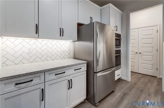 a kitchen with appliances and a refrigerator