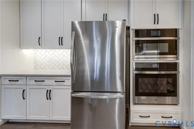 a view of kitchen with stainless steel appliances wooden cabinet and cabinet