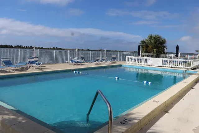 a view of a swimming pool with outdoor seating