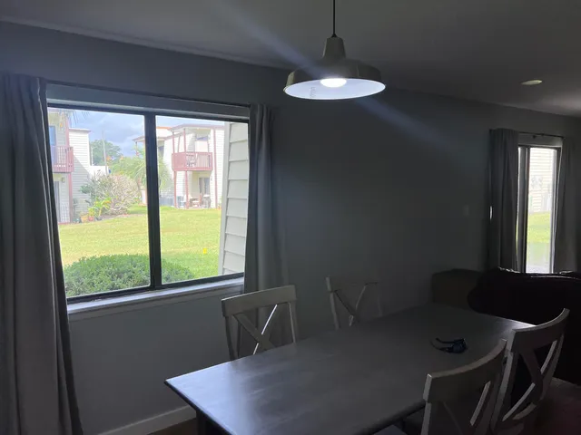 a view of a dining room with a table and chairs