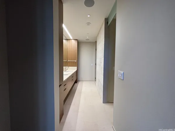 a spacious bathroom with a double vanity sink and a mirror