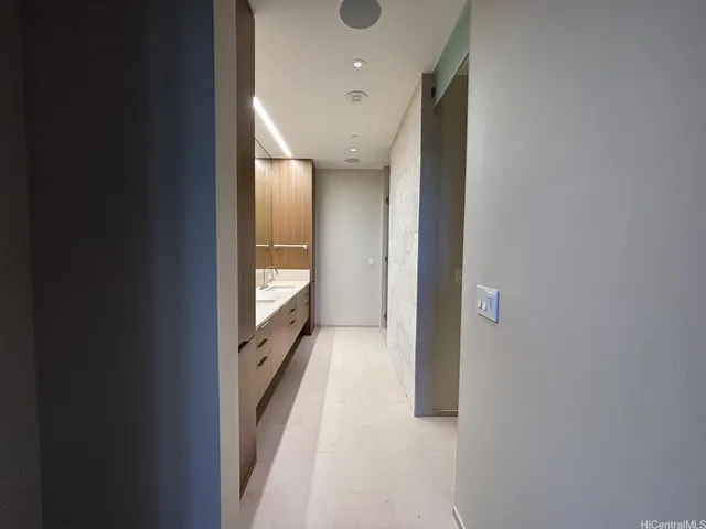 a spacious bathroom with a double vanity sink and a mirror