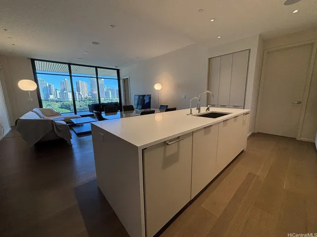 a living room with stainless steel appliances granite countertop furniture and a kitchen view