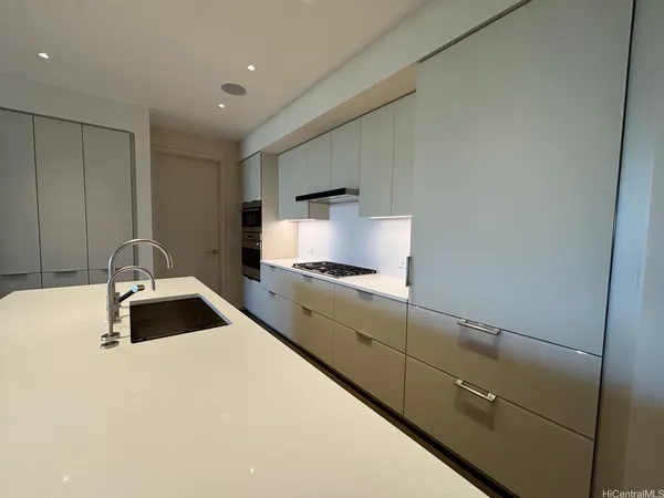 a kitchen with a sink and a refrigerator