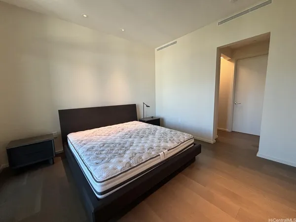 a bed sitting in a bedroom next to a cabinet