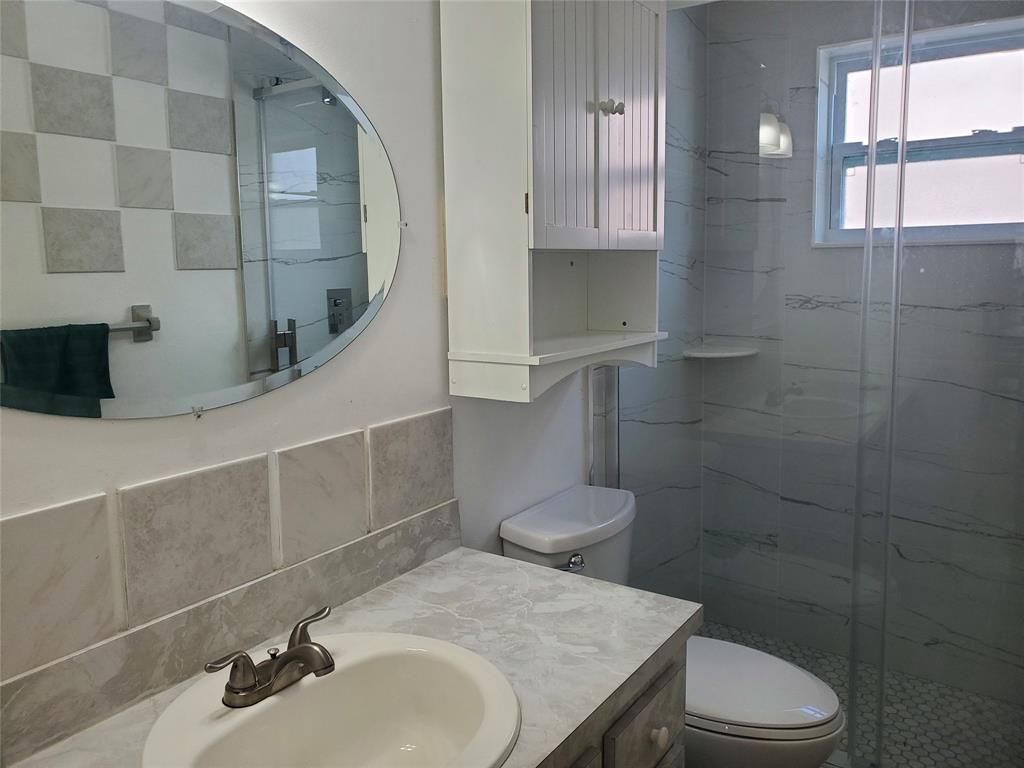 5300 Washington Street, Unit 114C Hollywood, FL 33021 - Photo 15 of 25 a bathroom with a sink a toilet and shower