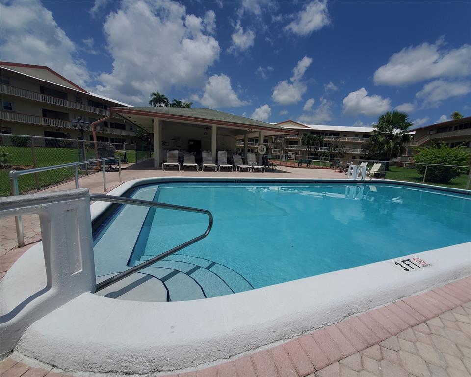 5300 Washington Street, Unit 114C Hollywood, FL 33021 - Photo 17 of 25 a swimming pool with outdoor seating and barbeque oven