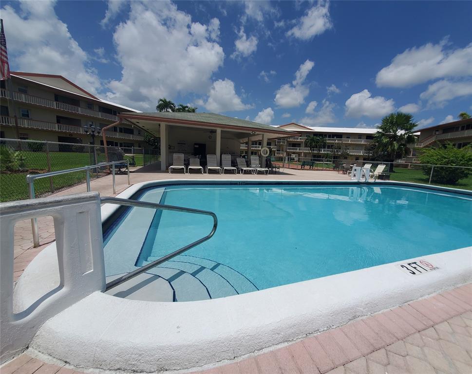5300 Washington Street, Unit 114C Hollywood, FL 33021 - Photo 18 of 25 a view of a swimming pool with outdoor seating