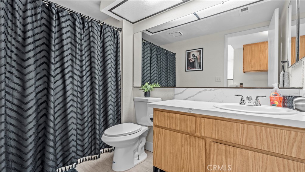 9713 La Jolla Drive, Unit B Rancho Cucamonga, CA 91701 - Photo 12 of 23 a bathroom with a sink a toilet and a mirror