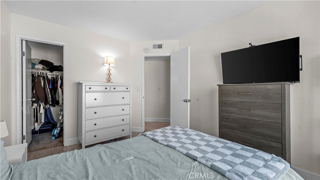 9713 La Jolla Drive, Unit B Rancho Cucamonga, CA 91701 - Photo 13 of 23 a bedroom with a bed and a flat screen tv
