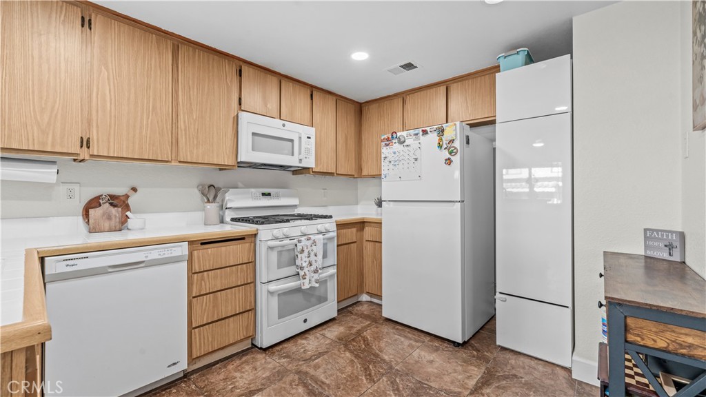 9713 La Jolla Drive, Unit B Rancho Cucamonga, CA 91701 - Photo 20 of 23 a kitchen with stainless steel appliances granite countertop a refrigerator sink and cabinets