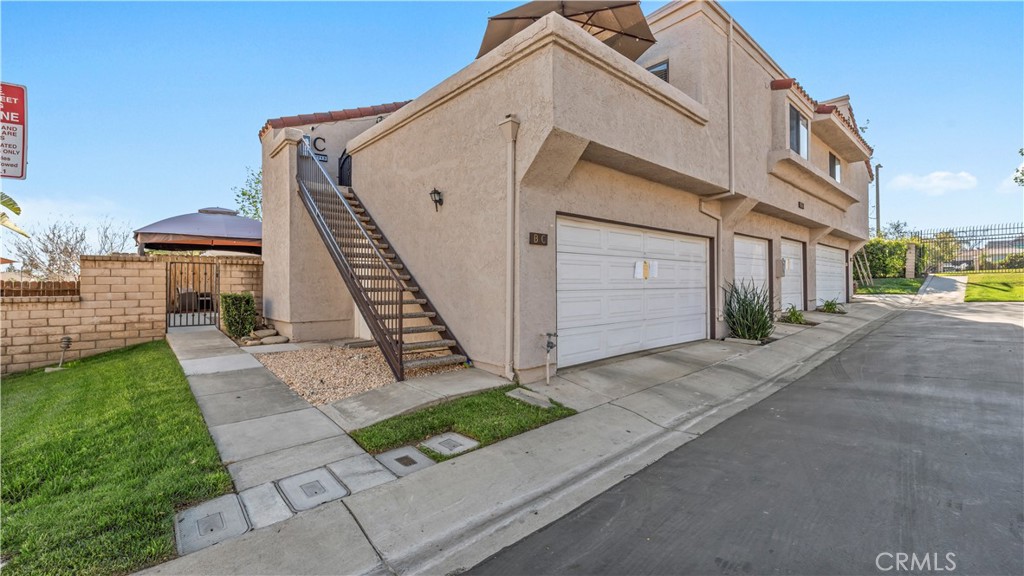 9713 La Jolla Drive, Unit B Rancho Cucamonga, CA 91701 - Photo 2 of 23 a front view of a house with a yard and garage