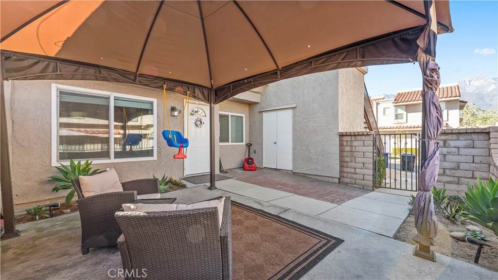 9713 La Jolla Drive, Unit B Rancho Cucamonga, CA 91701 - Photo 6 of 23 a living room filled with furniture and a umbrella