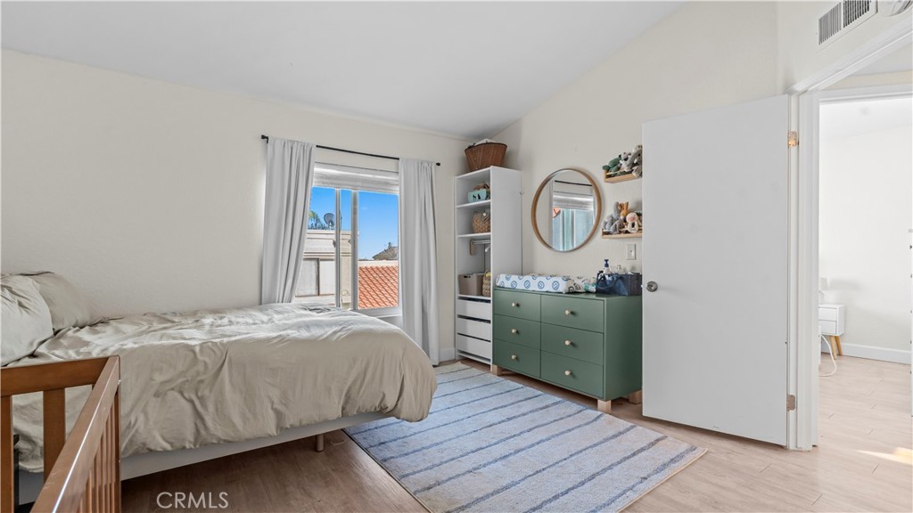 9713 La Jolla Drive, Unit B Rancho Cucamonga, CA 91701 - Photo 10 of 23 a bedroom with a bed and a mirror