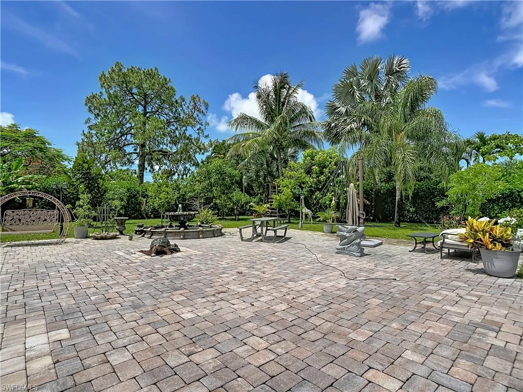 2280 Capri Court Naples, FL 34105 - Photo 36 of 49 a view of a backyard with a bench
