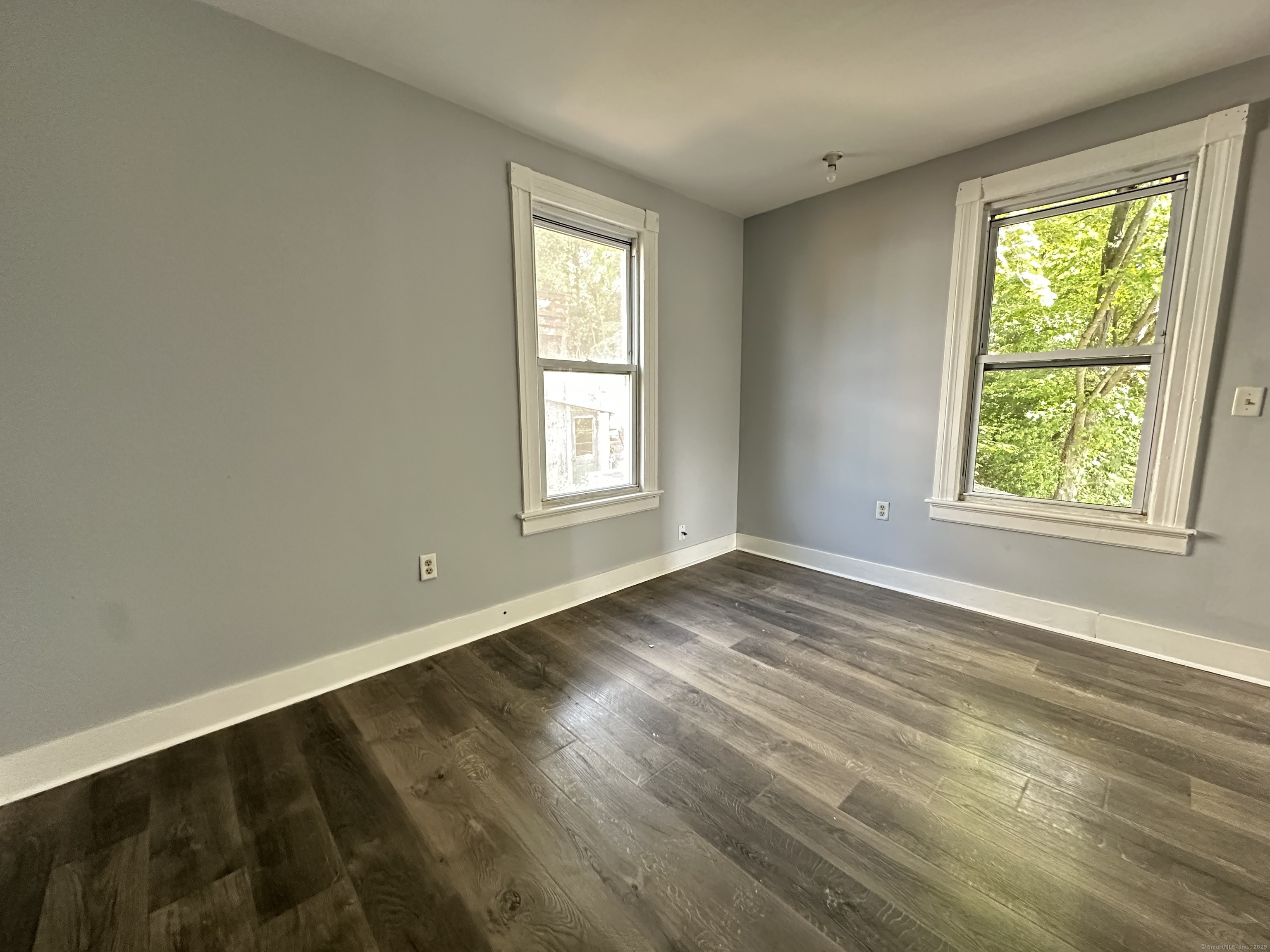 12 Rockwood Avenue Ansonia, CT 06401 - Photo 12 of 15 an empty room with wooden floor and windows