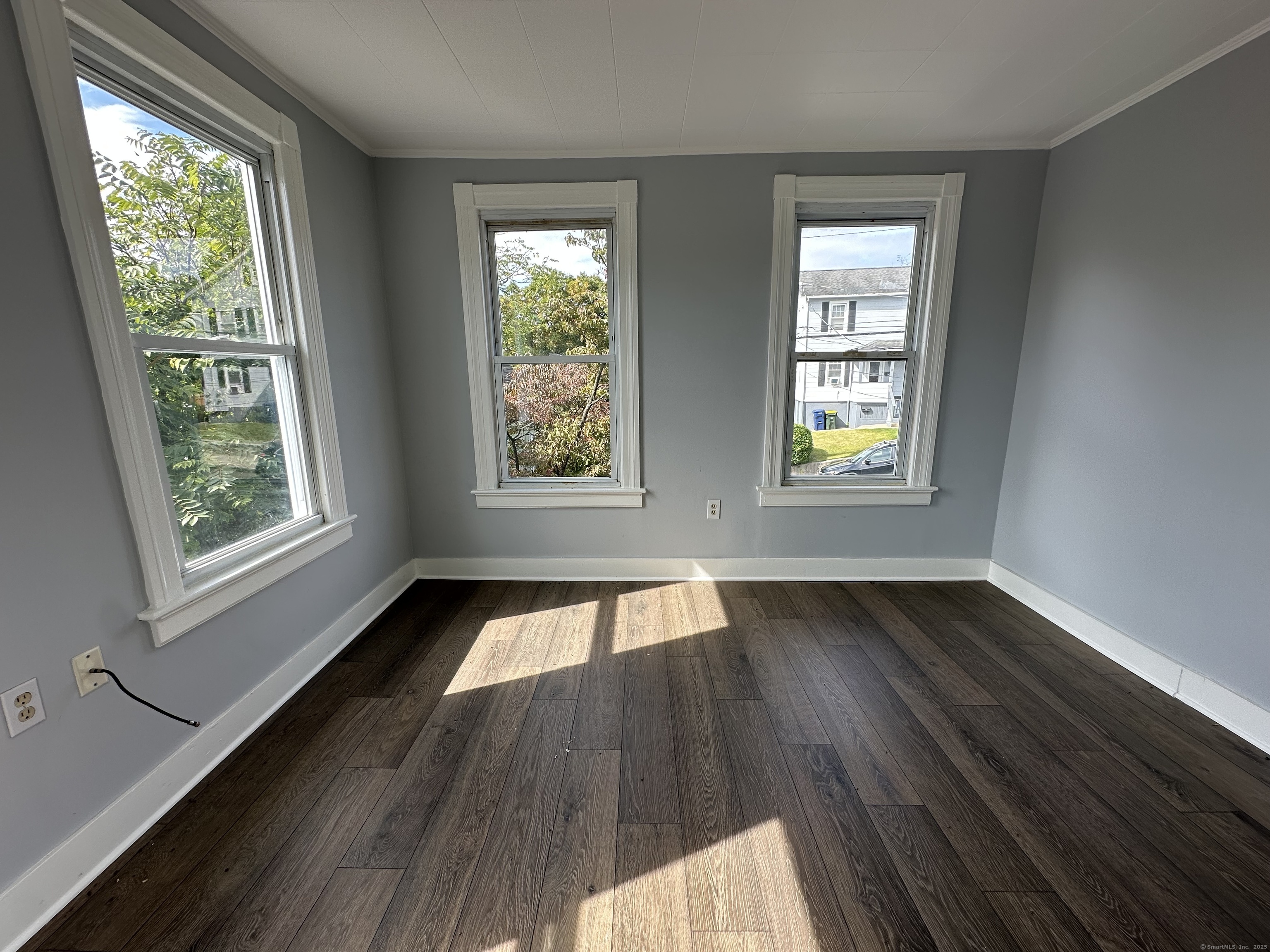 12 Rockwood Avenue Ansonia, CT 06401 - Photo 2 of 15 a view of an empty room and wooden floor and window