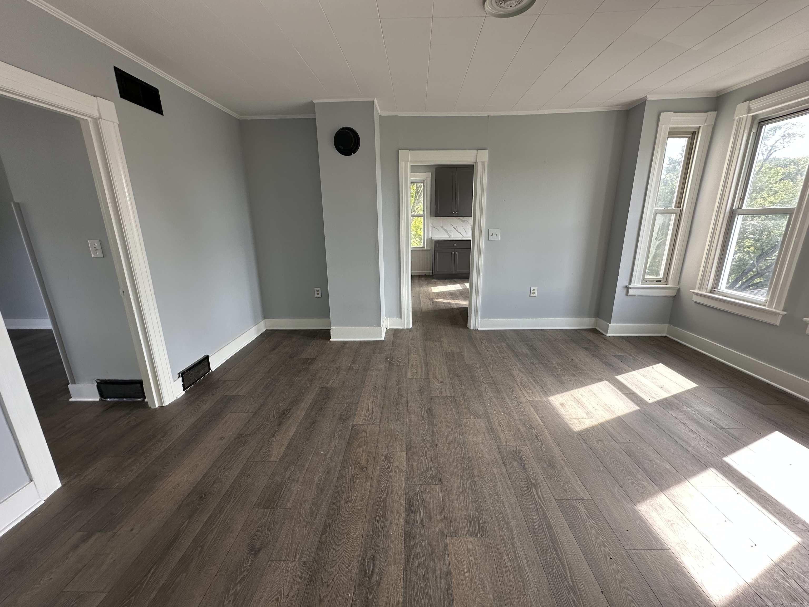 12 Rockwood Avenue Ansonia, CT 06401 - Photo 3 of 15 an empty room with wooden floor and windows