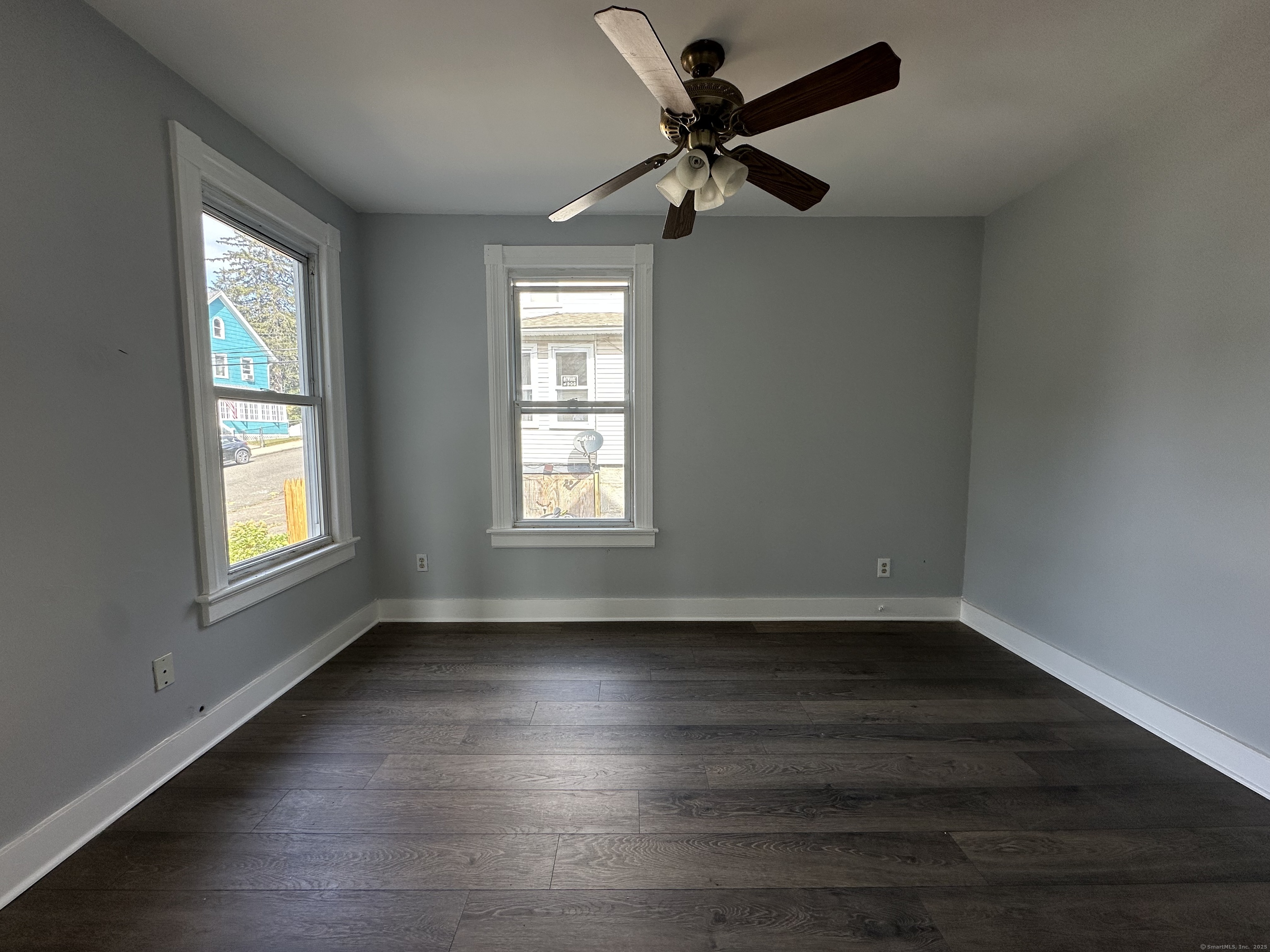 12 Rockwood Avenue Ansonia, CT 06401 - Photo 5 of 15 a view of an empty room with wooden floor and a window