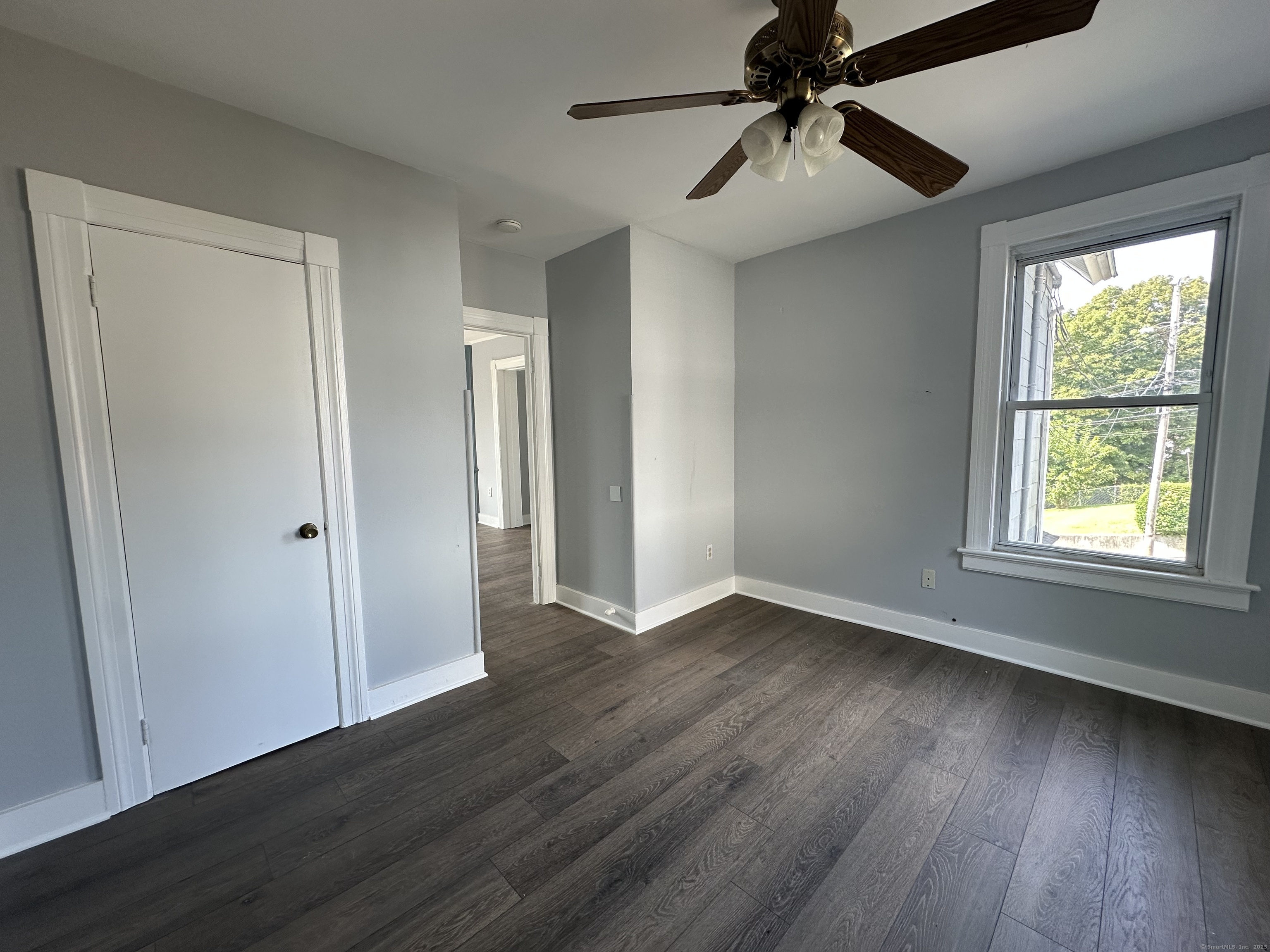 12 Rockwood Avenue Ansonia, CT 06401 - Photo 6 of 15 a view of an empty room with window and wooden floor