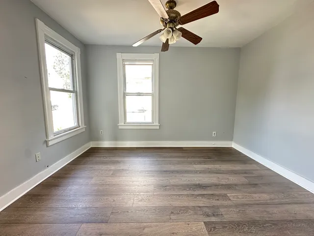 wooden floor in an empty room with a window