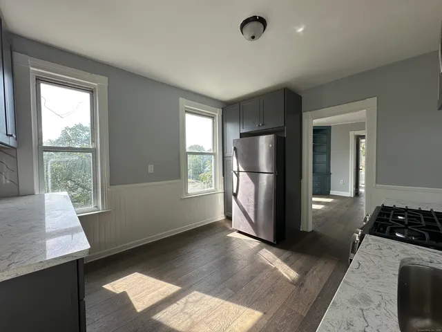 a kitchen with stainless steel appliances granite countertop a refrigerator and a sink